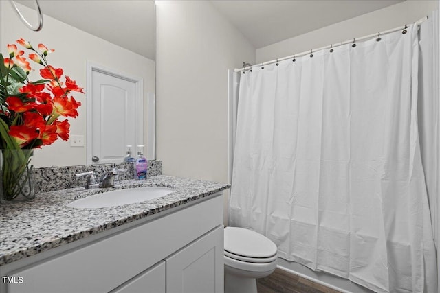 bathroom with vanity, toilet, a shower with shower curtain, and hardwood / wood-style flooring