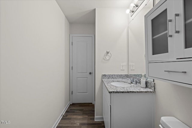 bathroom with vanity, hardwood / wood-style floors, and toilet