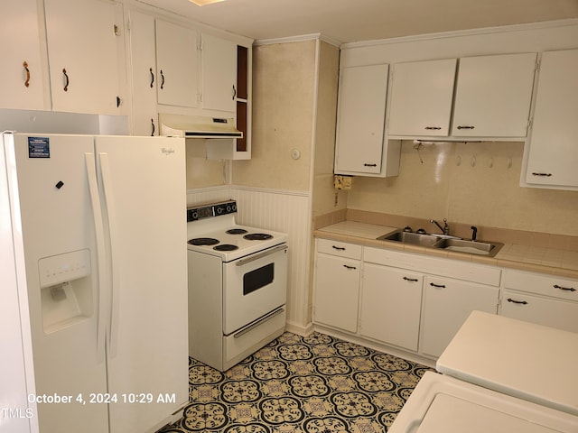 kitchen with white cabinets, tile counters, sink, and white appliances