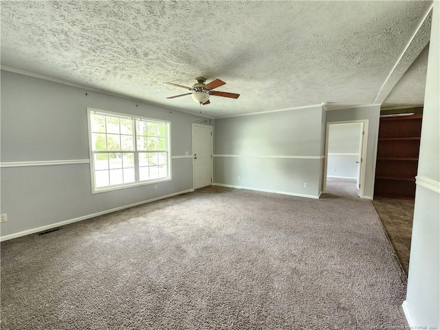 carpeted spare room with ceiling fan and a textured ceiling