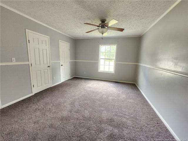 carpeted spare room featuring ceiling fan, crown molding, and a textured ceiling