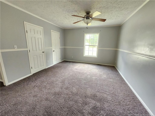 carpeted spare room with ceiling fan, ornamental molding, and a textured ceiling