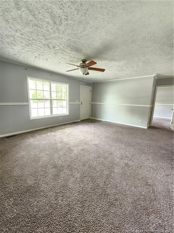 spare room with carpet floors, ceiling fan, and a textured ceiling