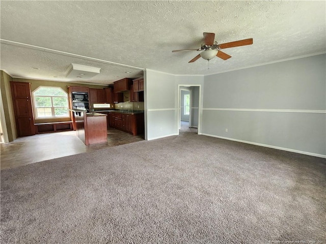 unfurnished living room with ceiling fan, a textured ceiling, and dark carpet