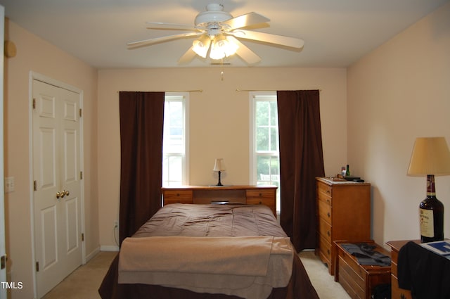 bedroom featuring light carpet and ceiling fan