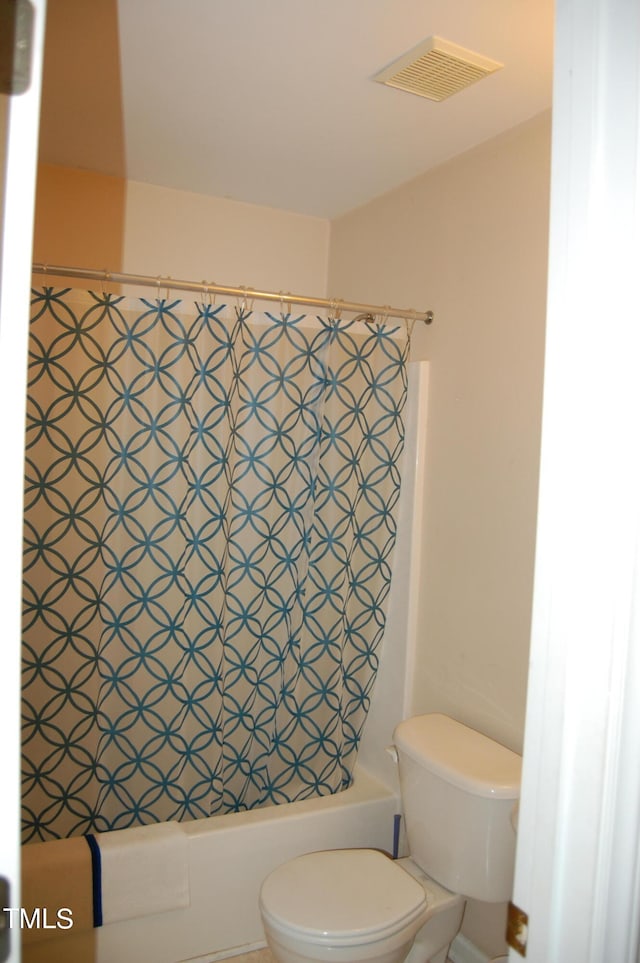 bathroom with toilet and shower / bath combo