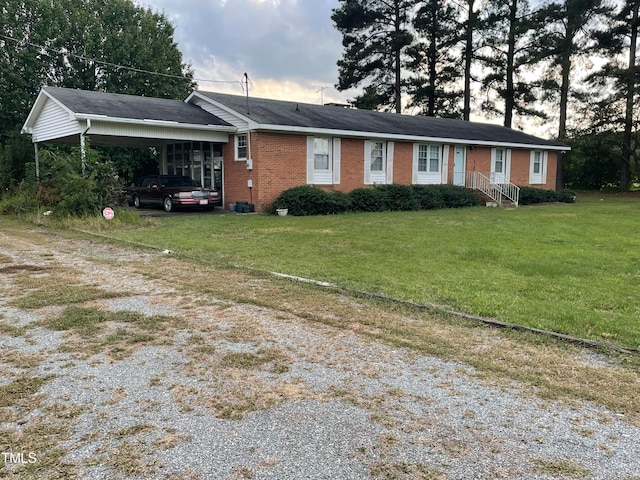 single story home featuring a front lawn and a carport