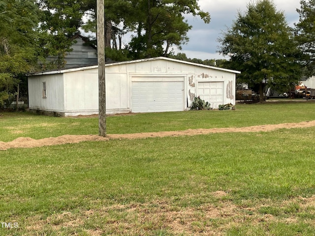 garage featuring a lawn