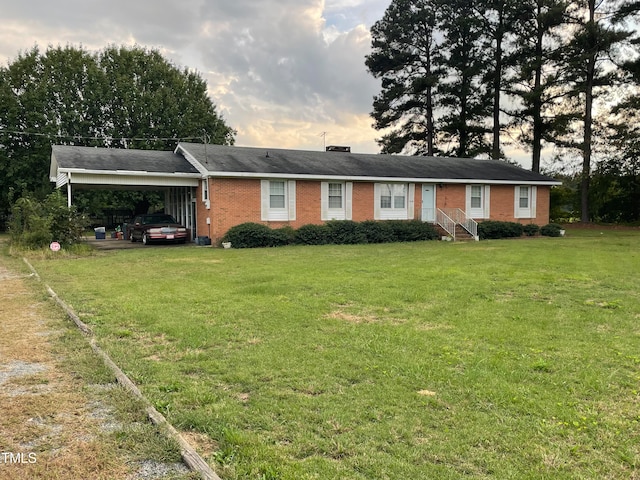 ranch-style house with a lawn and a carport