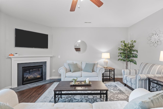 living room with ceiling fan and wood-type flooring