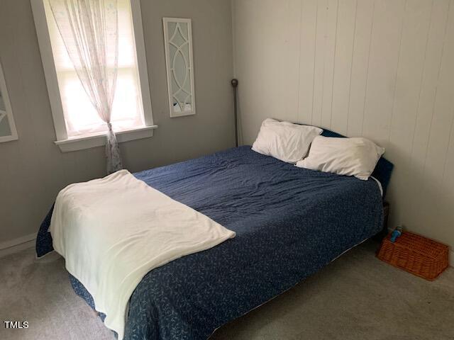 bedroom featuring light carpet