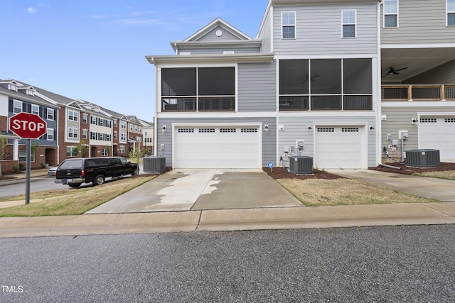 view of front of home featuring a garage and central air condition unit