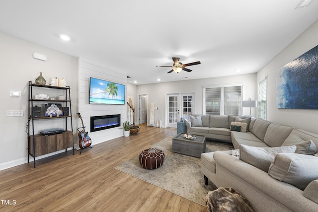 living room with wood-type flooring, french doors, and ceiling fan