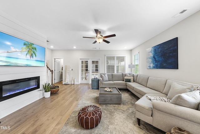 living room featuring hardwood / wood-style floors, french doors, and ceiling fan