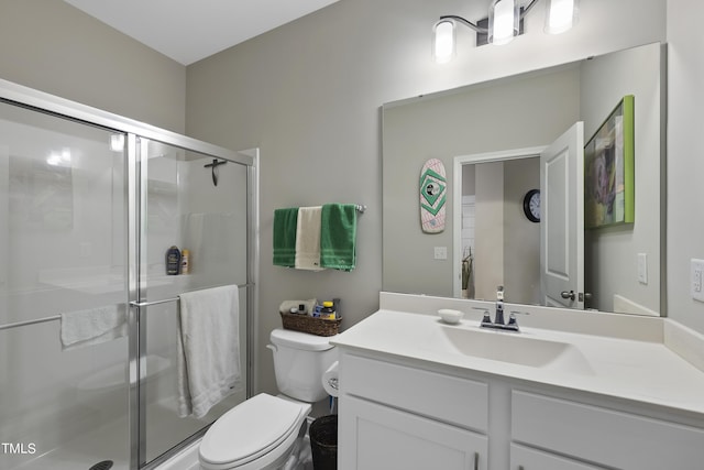 bathroom featuring walk in shower, vanity, and toilet