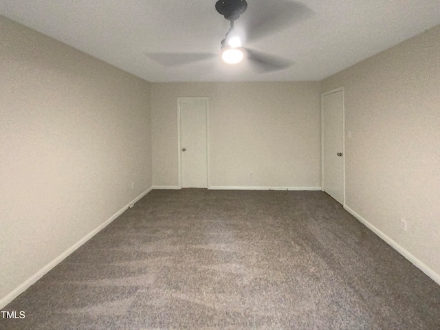 unfurnished room featuring ceiling fan, a textured ceiling, and dark carpet