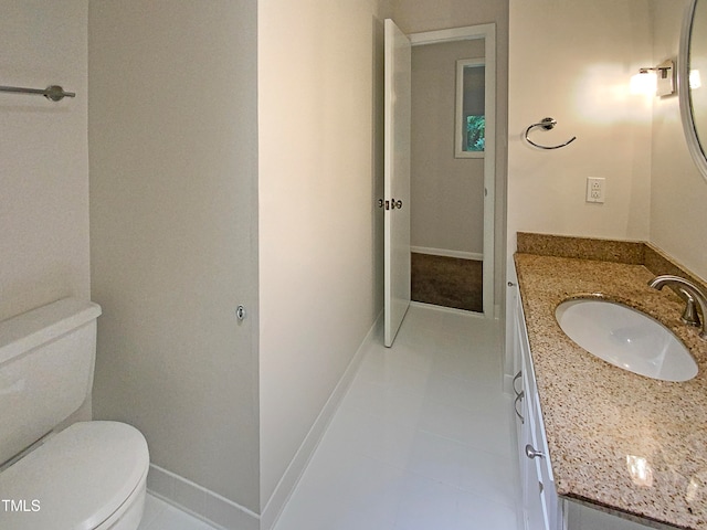 bathroom with vanity, toilet, and tile patterned floors