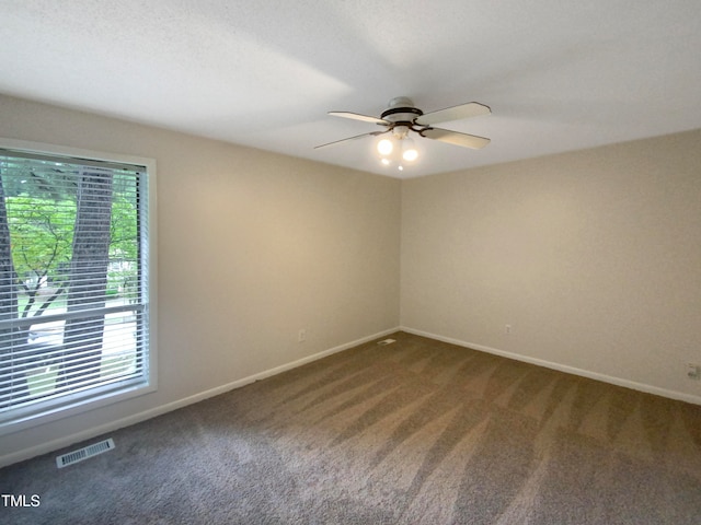 carpeted spare room featuring ceiling fan