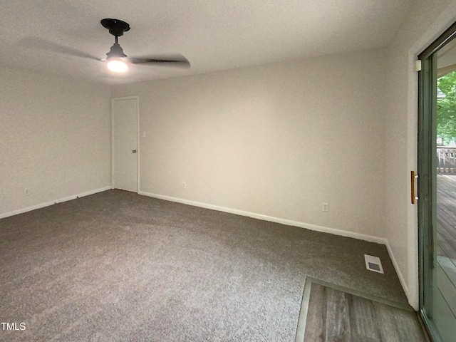 carpeted empty room with ceiling fan and a textured ceiling