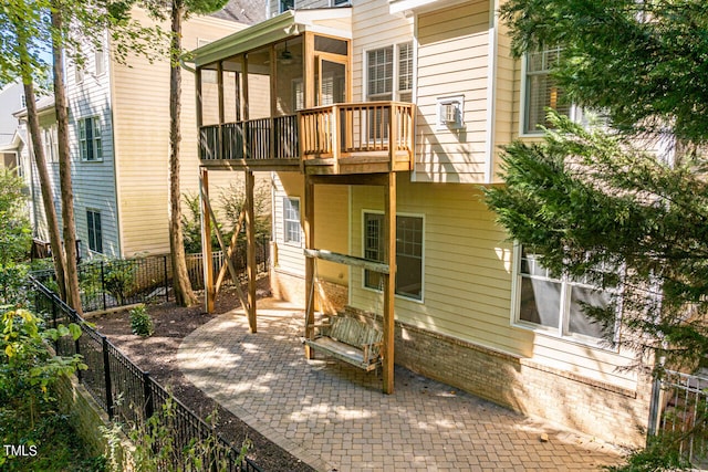 rear view of property with a balcony and a patio