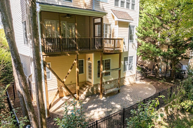 rear view of house with ceiling fan and a patio