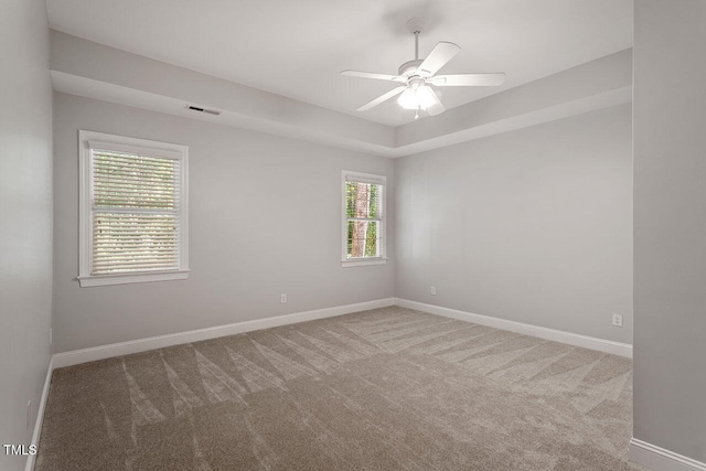 unfurnished room with carpet floors, ceiling fan, and a healthy amount of sunlight