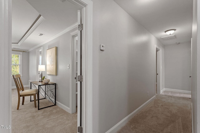 corridor with crown molding and light carpet