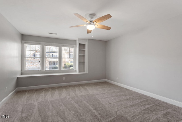 unfurnished room with carpet flooring and ceiling fan