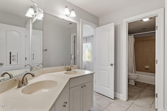 full bathroom featuring tile patterned flooring, shower / bathtub combination with curtain, vanity, and toilet