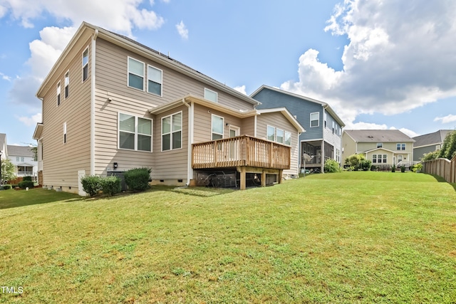 rear view of property with a deck and a yard