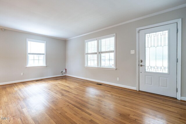 entryway featuring crown molding, plenty of natural light, and hardwood / wood-style flooring