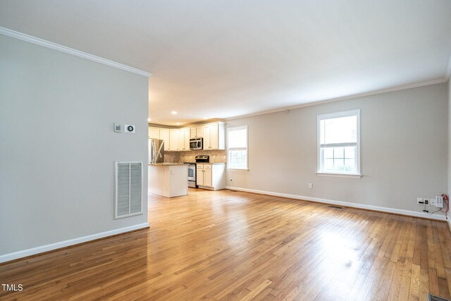 unfurnished living room featuring light hardwood / wood-style floors and ornamental molding