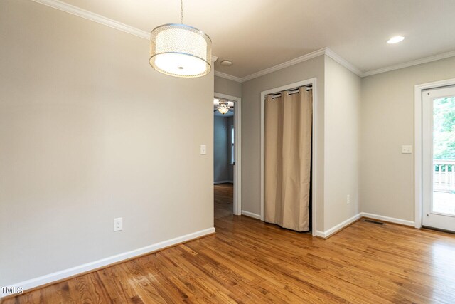 interior space with light wood-type flooring and crown molding