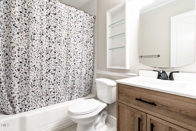 bathroom with vanity, ornamental molding, and toilet