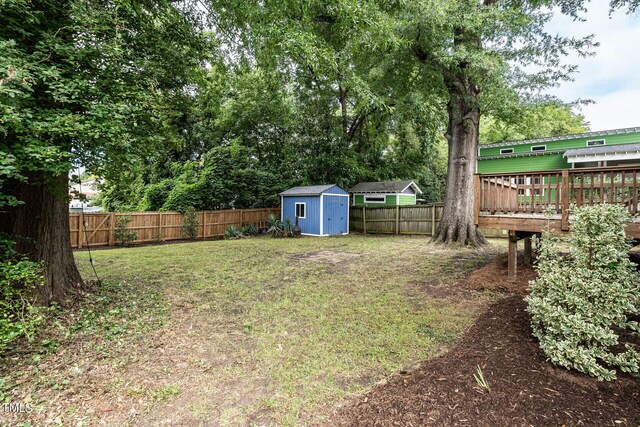 view of yard with a storage shed and a deck