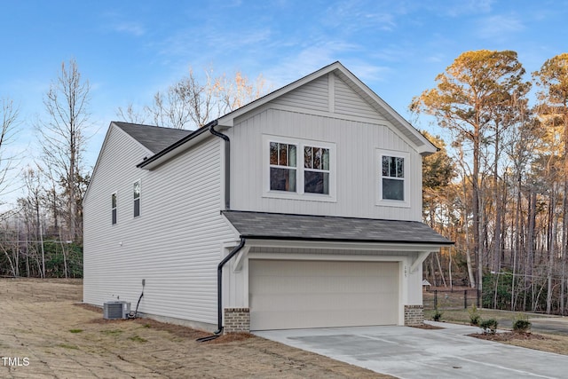 view of home's exterior featuring cooling unit and a garage