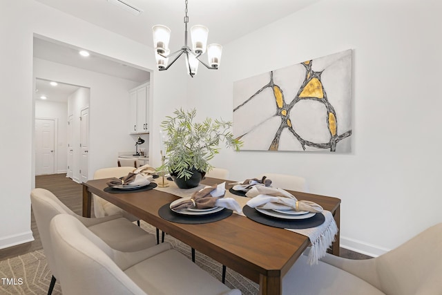 dining space featuring a chandelier and dark hardwood / wood-style floors