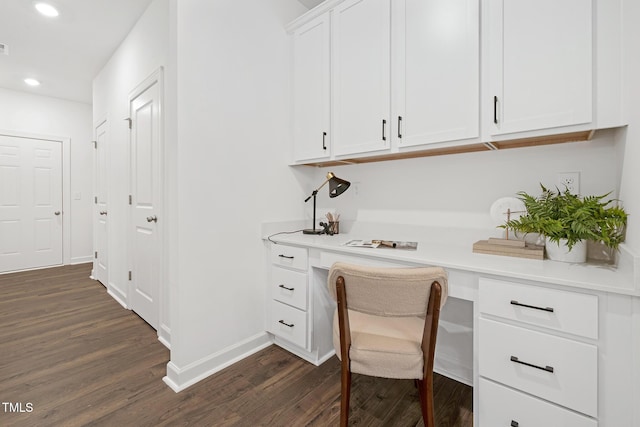 office featuring dark hardwood / wood-style flooring and built in desk