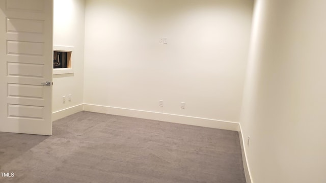 unfurnished room featuring carpet flooring and baseboards