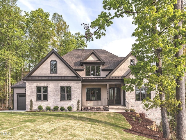 144 W Beech Slope Ct, Chapel Hill, NC 27517 - craftsman-style house with covered porch, a standing seam roof, roof with shingles, a front lawn, and stone siding