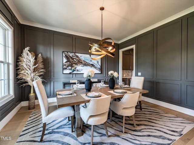 144 W Beech Slope Ct, Chapel Hill, NC 27517 - dining area with a decorative wall, light wood-style flooring, and a chandelier