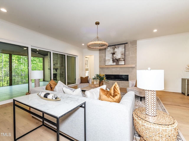 144 W Beech Slope Ct, Chapel Hill, NC 27517 - living area featuring crown molding, a tiled fireplace, recessed lighting, and wood finished floors