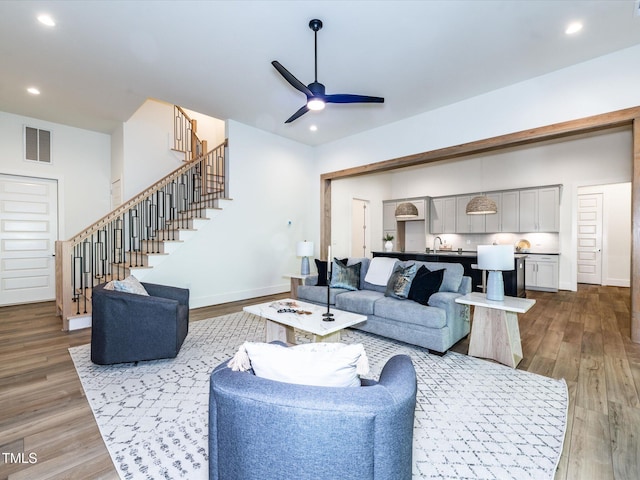 144 W Beech Slope Ct, Chapel Hill, NC 27517 - living area with visible vents, a ceiling fan, wood finished floors, and stairway