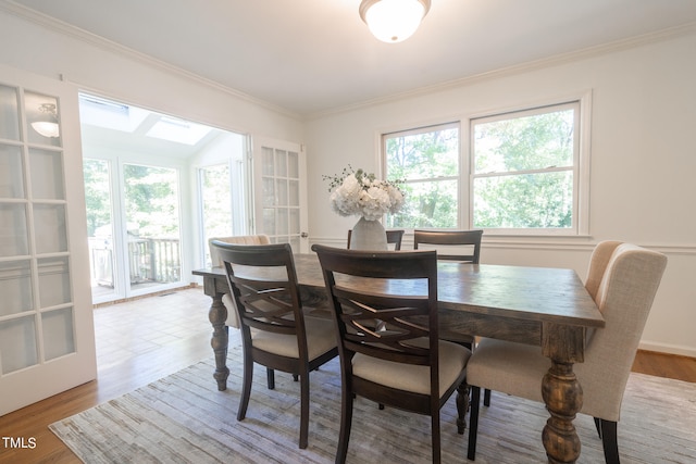 dining space featuring ornamental molding and hardwood / wood-style floors