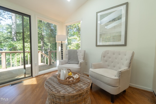 sitting room featuring hardwood / wood-style flooring, a healthy amount of sunlight, and vaulted ceiling