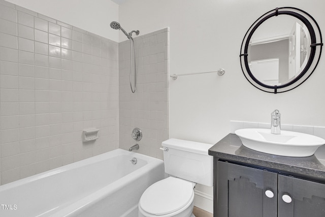 full bathroom featuring vanity, toilet, and tiled shower / bath