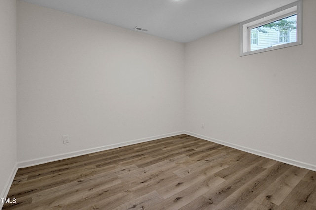 unfurnished room featuring hardwood / wood-style flooring