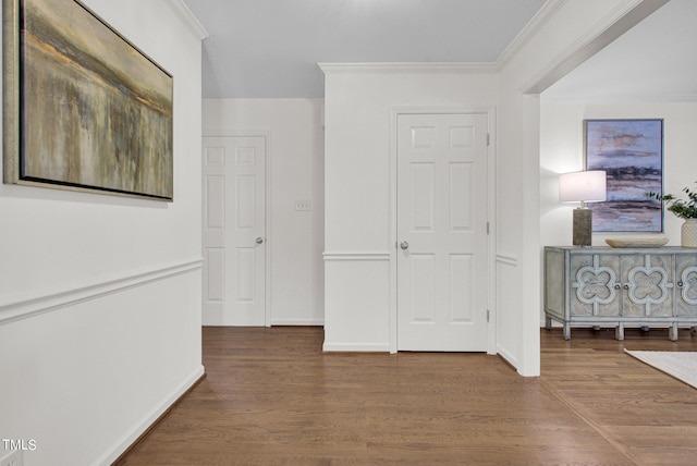 corridor with hardwood / wood-style flooring and crown molding