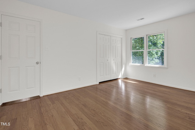 unfurnished bedroom with dark wood-type flooring