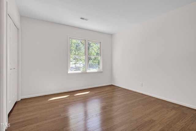 spare room with dark hardwood / wood-style floors